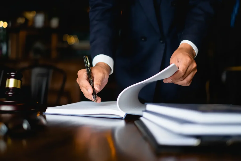 Kehoe Sands Law attorney in Hillsboro, Oregon signing legal documents for a client consultation.