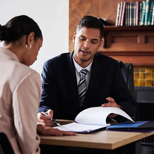 Lawyer with a client reviewing paperwork